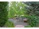Landscaped common area with seating, mature trees, and gravel paths, creating a serene outdoor space at 640 11Th St # 302, Golden, CO 80401