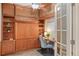 Cozy office space features custom built-in cabinets and shelving and a murphy bed for flexible use at 640 11Th St # 302, Golden, CO 80401