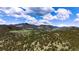 Breathtaking aerial view showcasing the lush green landscape and mountain scenery at 6066 Crawford Gulch Rd, Golden, CO 80403