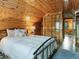 Cozy bedroom with wooden accents, comfortable bedding, closet, and access to a hallway at 6066 Crawford Gulch Rd, Golden, CO 80403