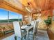 Dining room with wood ceiling and walls, long table with seating and mountain view at 6066 Crawford Gulch Rd, Golden, CO 80403