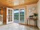 Light-filled entryway with tiled floors, an open door to a deck, and a side table at 6066 Crawford Gulch Rd, Golden, CO 80403