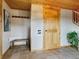 Inviting entryway with tiled flooring, bench seating, hooks, and a wooden door at 6066 Crawford Gulch Rd, Golden, CO 80403