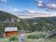 Idyllic cabin nestled amidst a scenic landscape with lush greenery and mountain views at 6066 Crawford Gulch Rd, Golden, CO 80403
