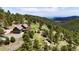 A-frame home with decks on lush, green, tree-covered acreage offering distant views at 6066 Crawford Gulch Rd, Golden, CO 80403