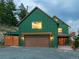 Charming green two-story home with a gravel driveway and a covered garage at 6066 Crawford Gulch Rd, Golden, CO 80403