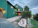 A-frame home with stone entrance, landscaping, outdoor lighting and views at 6066 Crawford Gulch Rd, Golden, CO 80403