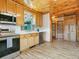 Bright kitchen features stainless steel appliances, light wood cabinets and ample counter space at 6066 Crawford Gulch Rd, Golden, CO 80403