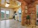 Kitchen with wood paneled walls and cabinets, stainless appliances, and french doors to the outside at 6066 Crawford Gulch Rd, Golden, CO 80403