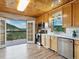 Bright kitchen with light wood cabinets, stainless steel appliances, and French doors to the outdoors at 6066 Crawford Gulch Rd, Golden, CO 80403