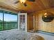 Bedroom with wood-paneled walls and ceiling, carpeting, and outdoor access at 6066 Crawford Gulch Rd, Golden, CO 80403