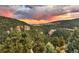 Spectacular landscape view with colorful sunset sky and rolling green mountains at 6066 Crawford Gulch Rd, Golden, CO 80403