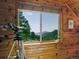 Window view from a wood-paneled room featuring a telescope and mountain landscape at 6066 Crawford Gulch Rd, Golden, CO 80403