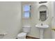 Well-lit half bath with pedestal sink and ceramic tile at 5483 Ben Park Cir, Parker, CO 80134