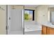 Bright bathroom featuring double sink, walk-in shower, and soaking tub at 5483 Ben Park Cir, Parker, CO 80134