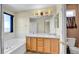 Bright bathroom featuring double sink vanity and a soaking tub at 5483 Ben Park Cir, Parker, CO 80134