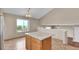 Bright eat-in kitchen with a large island, tile floors, and a vaulted ceiling at 5483 Ben Park Cir, Parker, CO 80134