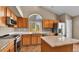 Well-appointed kitchen with wooden cabinets, stainless steel appliances, and granite countertops at 5483 Ben Park Cir, Parker, CO 80134