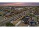 Stunning aerial view of a neighborhood with a mix of homes, businesses, and roadways at sunset at 1990 Ulster St, Denver, CO 80220