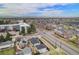Sweeping aerial view showcasing the neighborhood and distant mountain views at 1990 Ulster St, Denver, CO 80220