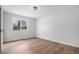 Bedroom with wood floors and a bright window, creating a cozy and inviting atmosphere at 1990 Ulster St, Denver, CO 80220
