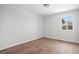 Bedroom with three windows and wood flooring, offering a bright and inviting atmosphere at 1990 Ulster St, Denver, CO 80220