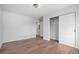 Bedroom featuring wood floors, closet and bright lighting for comfortable living at 1990 Ulster St, Denver, CO 80220