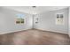 Bedroom with natural light from three windows and beautiful wood flooring throughout the space at 1990 Ulster St, Denver, CO 80220