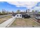 Charming updated home featuring a freshly landscaped front yard and modern exterior paint scheme at 1990 Ulster St, Denver, CO 80220