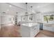 Open-concept kitchen with island and farmhouse sink, perfect for entertaining or Gathering gatherings and new appliances at 1990 Ulster St, Denver, CO 80220