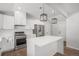Bright kitchen featuring an island with seating and updated stainless steel appliances at 1990 Ulster St, Denver, CO 80220