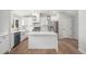 Beautiful white kitchen with island, stainless steel appliances, and farmhouse sink at 1990 Ulster St, Denver, CO 80220