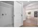 Bright laundry area with tile floors, storage, and a modern sliding door at 1990 Ulster St, Denver, CO 80220