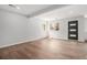 This renovated living room features light wood floors, modern recessed lighting and a modern black front door at 1990 Ulster St, Denver, CO 80220
