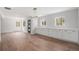 A new modern living room with light wood floors and lots of natural light coming in the many windows at 1990 Ulster St, Denver, CO 80220
