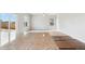Spacious living room with wood and carpet flooring, large windows, and neutral paint at 7220 Big Thompson Ct, Frederick, CO 80530
