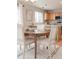 Bright dining area features a wood table with seating for four adjacent to the modern kitchen at 8458 Bluegrass Cir, Parker, CO 80134