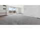 Bright living room with gray carpeting, built-in shelving, and access to balcony with decorative screening at 4570 E Yale Ave # 706, Denver, CO 80222