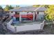 Spacious backyard with a red deck, stone accents, and a retaining wall, ideal for outdoor living at 6260 Rain Dance Trl, Littleton, CO 80125