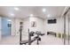 Finished basement, home gym with bench press and weight rack at 6260 Rain Dance Trl, Littleton, CO 80125