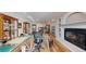 Bright basement setup, with a fireplace, display cases, and a table with a cutting mat at 6260 Rain Dance Trl, Littleton, CO 80125