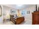 Cozy bedroom with neutral walls, a wooden sleigh bed, and an artful picture on the wall at 6260 Rain Dance Trl, Littleton, CO 80125