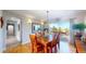 Elegant dining room with wood table, stylish lighting, and a sliding glass door to the deck at 6260 Rain Dance Trl, Littleton, CO 80125