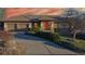 Beautiful single-story home with stone accents, mature landscaping, and a three-car garage at 6260 Rain Dance Trl, Littleton, CO 80125