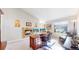 Well-lit home office featuring a fireplace, a large desk, and a comfortable chair at 6260 Rain Dance Trl, Littleton, CO 80125