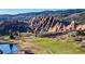 This community offers scenic views of unique rock formations and a lush green golf course at 6260 Rain Dance Trl, Littleton, CO 80125