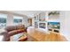 Cozy living room featuring a fireplace, hardwood flooring, and great natural light at 6260 Rain Dance Trl, Littleton, CO 80125