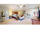 Spacious main bedroom with a ceiling fan, a wooden bed frame, and neutral decor at 6260 Rain Dance Trl, Littleton, CO 80125