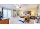 Spacious main bedroom with a ceiling fan, a king size bed, and neutral colored walls at 6260 Rain Dance Trl, Littleton, CO 80125