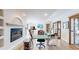 Bright office space with fireplace, hardwood floors, built in display cases and a large crafting table at 6260 Rain Dance Trl, Littleton, CO 80125
